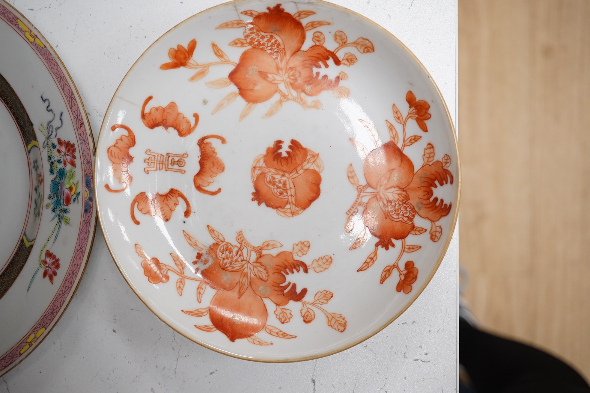 A Chinese iron-red ‘sanduo’ dish, 19th century and a Chinese famille rose plate, Yongzheng. famille rose plate 22.5cm diameter. Condition - poor to fair